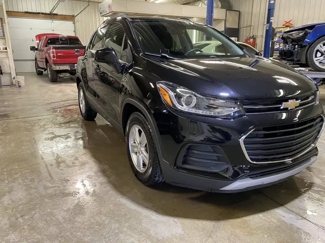 The same black Chevrolet Trax after the front-end repair, in the shop